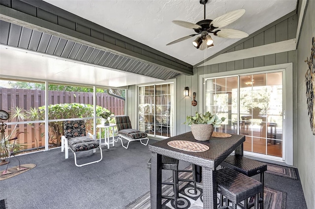 sunroom / solarium featuring ceiling fan, a healthy amount of sunlight, and vaulted ceiling