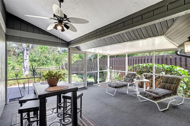 sunroom with ceiling fan and lofted ceiling