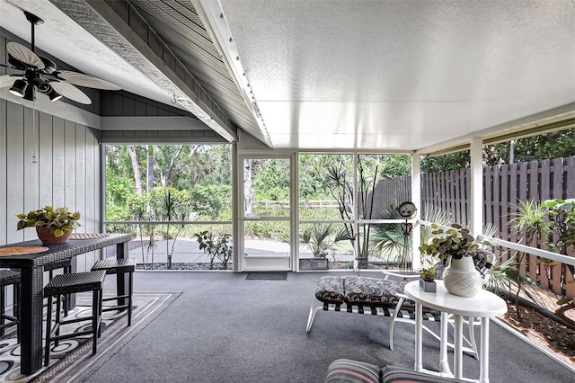 sunroom / solarium with lofted ceiling and ceiling fan