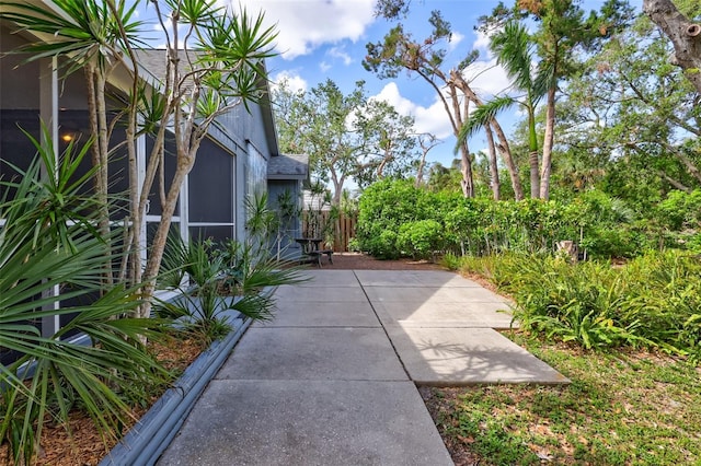 view of side of property with a patio area