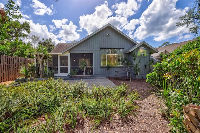 back of property with a patio and a sunroom