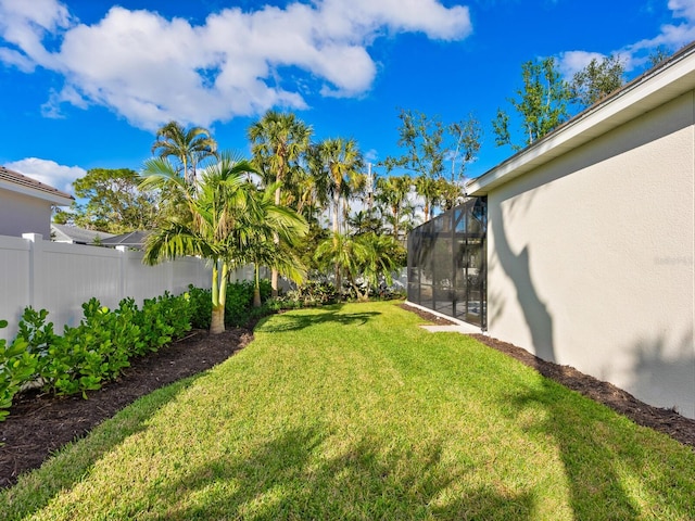 view of yard featuring glass enclosure