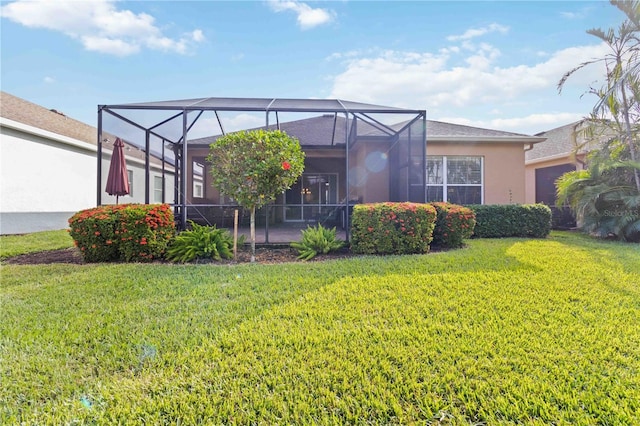 back of property featuring a lawn and glass enclosure