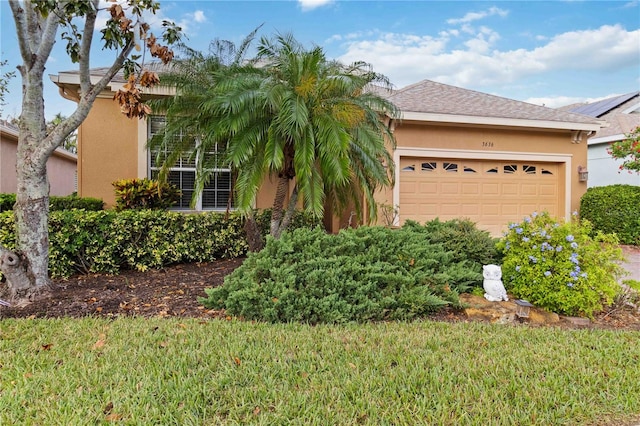 view of front facade featuring a garage and a front yard