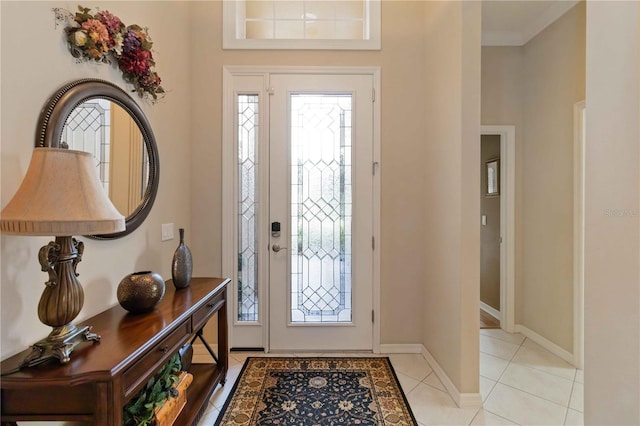 entryway featuring light tile patterned floors and ornamental molding