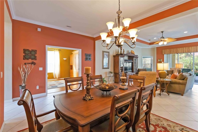 dining room featuring light tile patterned floors, ceiling fan with notable chandelier, and ornamental molding