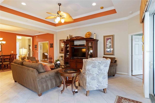 tiled living room featuring a tray ceiling, crown molding, and ceiling fan with notable chandelier