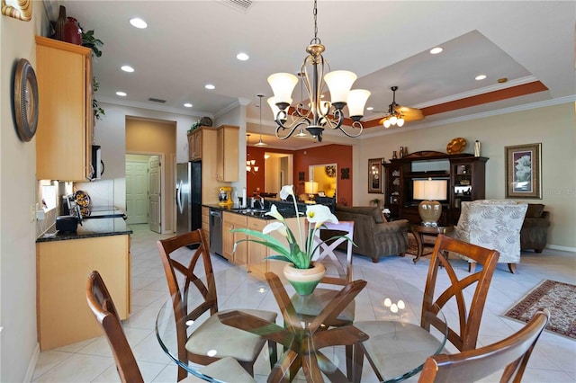 dining room featuring ceiling fan with notable chandelier, light tile patterned flooring, ornamental molding, and sink