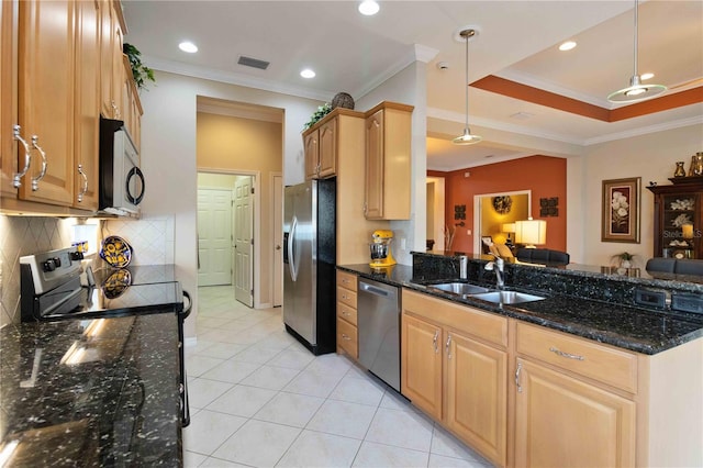 kitchen with sink, dark stone countertops, crown molding, decorative light fixtures, and appliances with stainless steel finishes