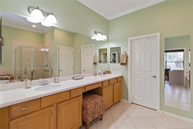 bathroom with tile patterned flooring, vanity, a shower with shower door, and ornamental molding