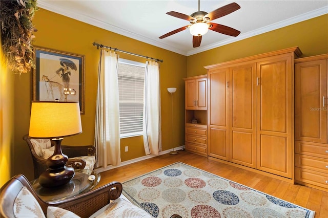 living area with light wood-type flooring, ceiling fan, and crown molding