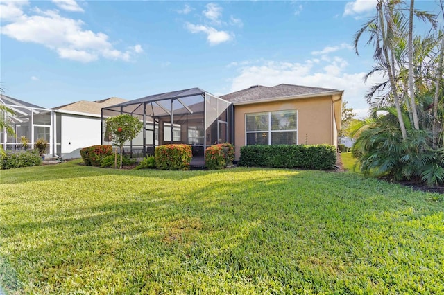 rear view of property featuring a lanai and a yard