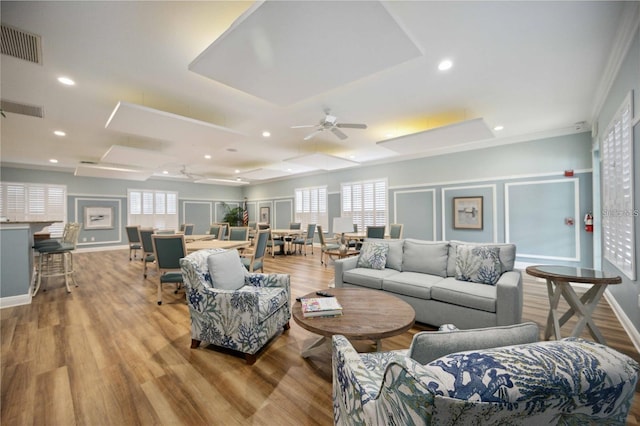 living room featuring ceiling fan, plenty of natural light, and light wood-type flooring