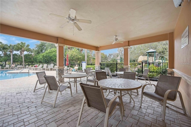 view of patio / terrace with a playground, ceiling fan, and a community pool