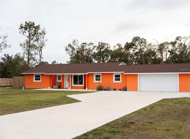 single story home featuring a front lawn and a garage