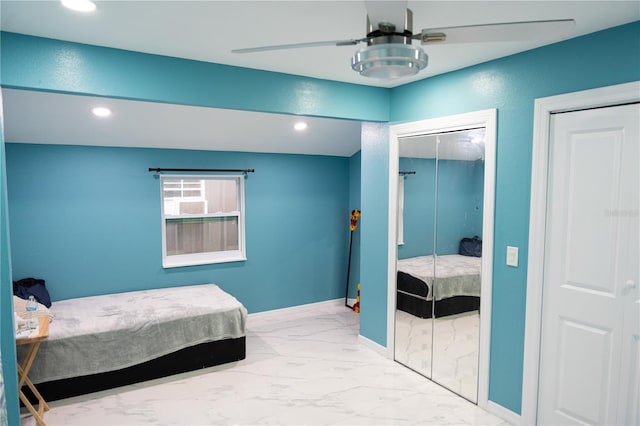 bedroom featuring ceiling fan and multiple closets