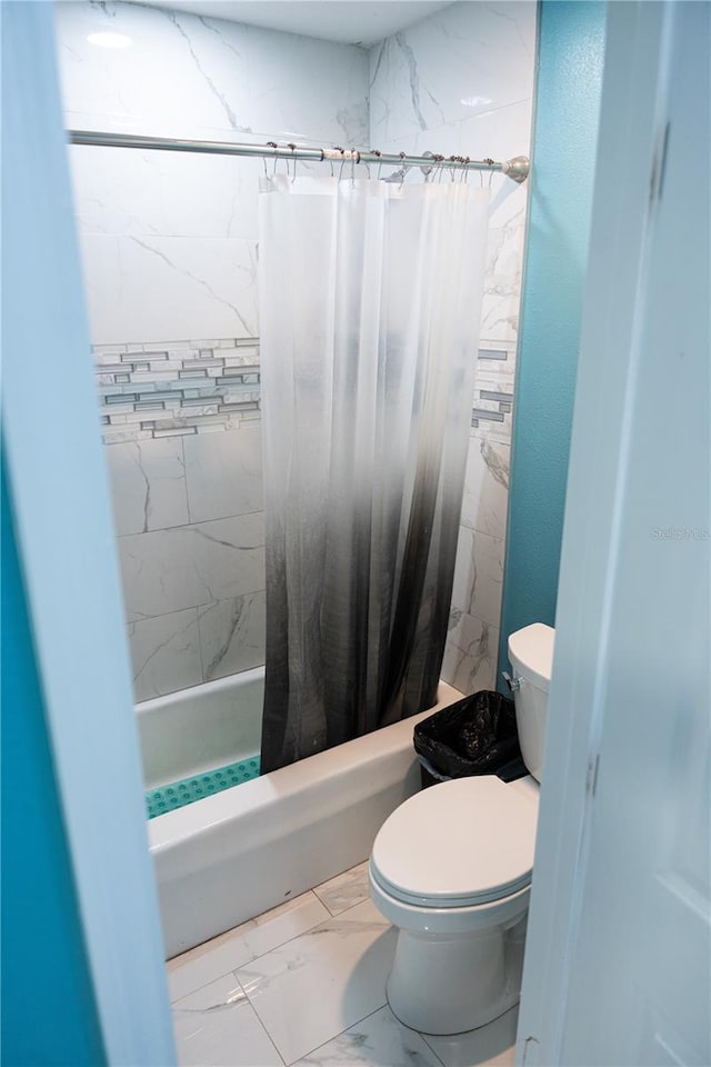 bathroom with shower / bath combo with shower curtain and toilet