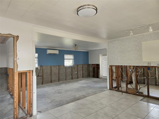 empty room with crown molding and a wall mounted air conditioner