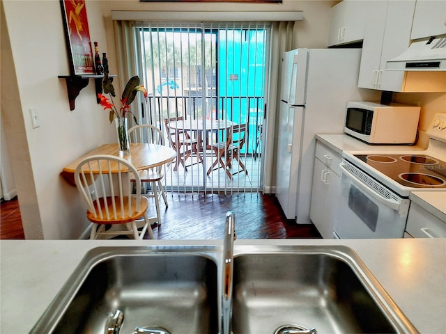 kitchen featuring white cabinetry, sink, white appliances, ventilation hood, and dark hardwood / wood-style flooring