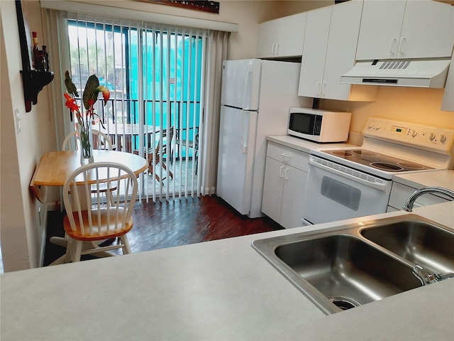 kitchen featuring dark hardwood / wood-style flooring, white cabinets, sink, ventilation hood, and white appliances