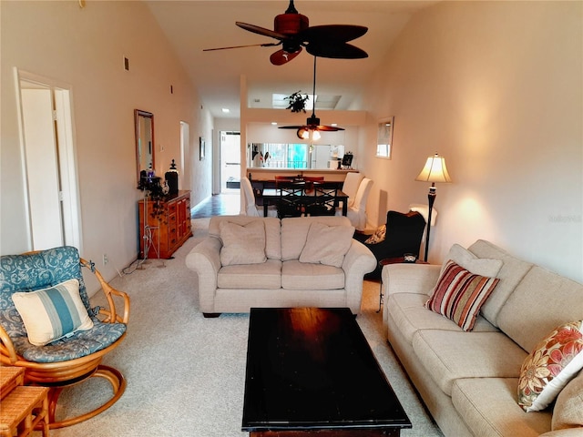 living room featuring ceiling fan, high vaulted ceiling, and carpet floors