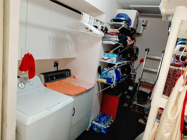 laundry area featuring washer and clothes dryer and cabinets