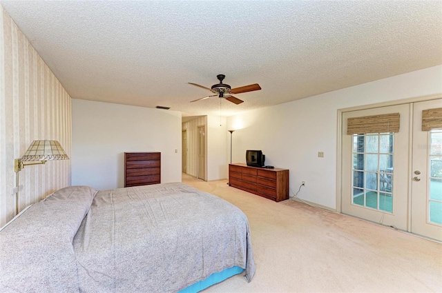 bedroom featuring french doors, a textured ceiling, access to exterior, light colored carpet, and ceiling fan