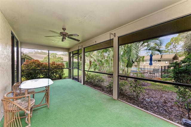 sunroom featuring ceiling fan