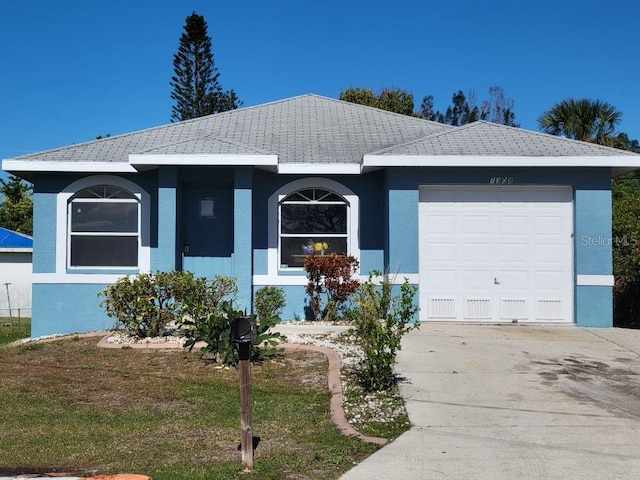 1308 72nd St E, Palmetto, FL 34221 - ranch-style house with concrete driveway, a garage, a tile roof, and stucco siding