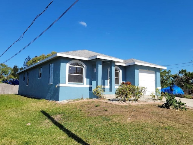 1308 72nd St E, Palmetto, FL 34221 - view of front of house featuring an attached garage and stucco siding