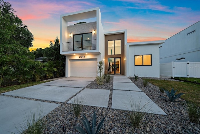 contemporary home with a garage and a balcony