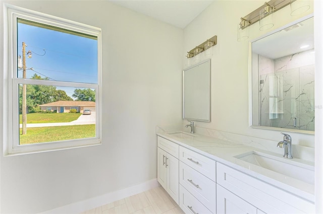 bathroom featuring a shower with door, vanity, and tile patterned flooring