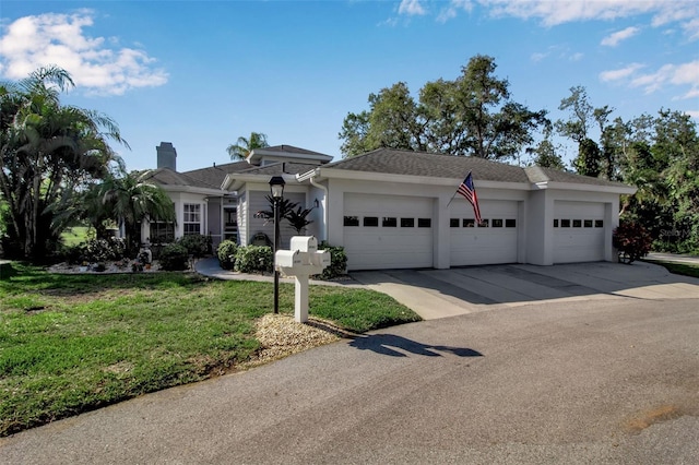 ranch-style house with a garage and a front yard