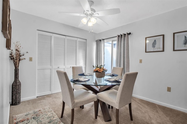 dining area with light carpet and ceiling fan