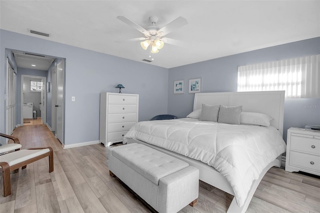 bedroom featuring multiple windows, ceiling fan, and light hardwood / wood-style flooring