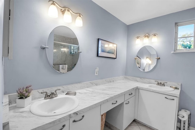 bathroom featuring tile patterned floors, vanity, and a shower