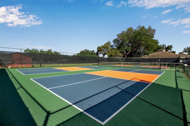 view of tennis court with basketball hoop