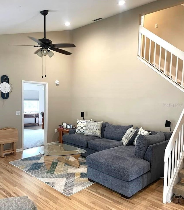 living room featuring light hardwood / wood-style flooring and ceiling fan