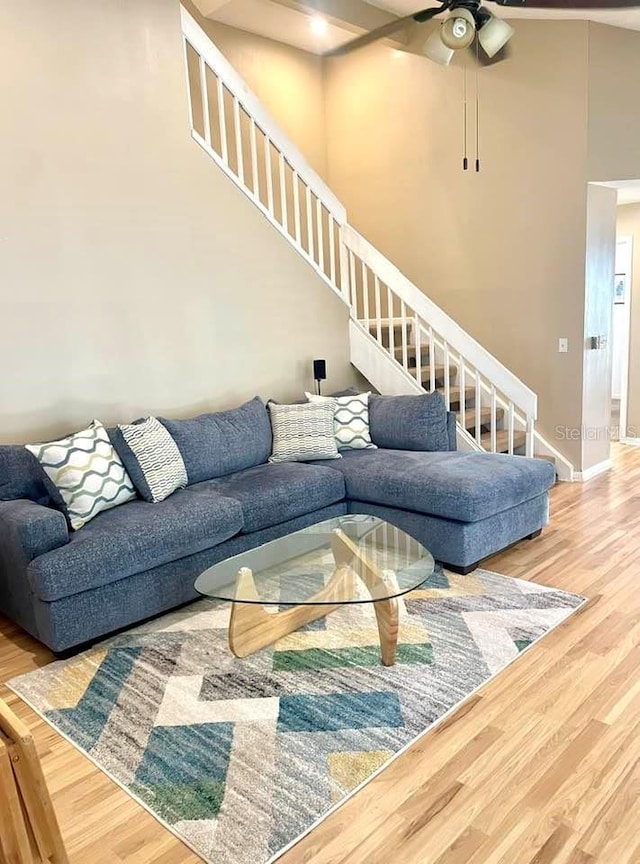 living room with hardwood / wood-style floors and ceiling fan