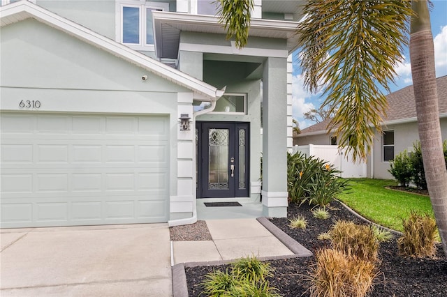 entrance to property with a lawn