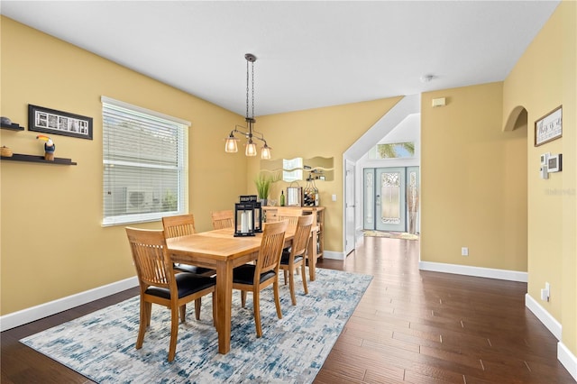 dining area featuring dark wood-type flooring