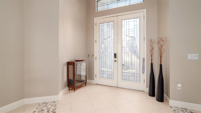 doorway to outside with french doors and light tile patterned floors