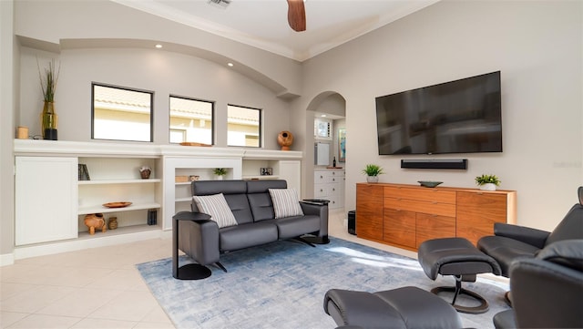 living room featuring ceiling fan, light tile patterned flooring, and ornamental molding