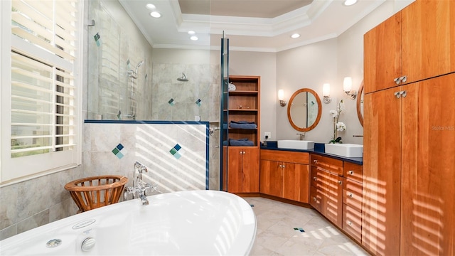 bathroom with plenty of natural light, ornamental molding, shower with separate bathtub, and a tray ceiling