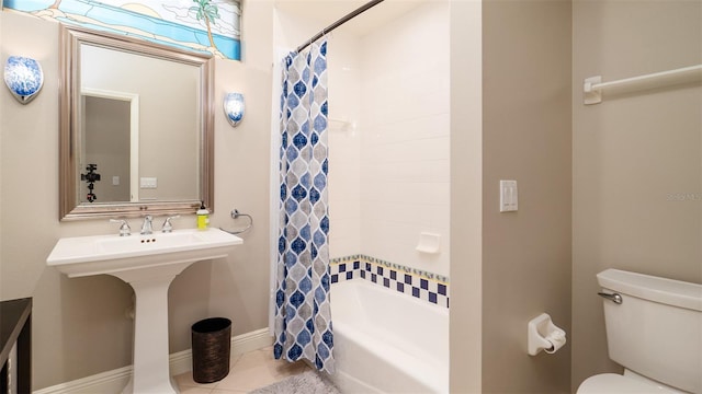 bathroom with tile patterned floors, shower / bath combination with curtain, and toilet