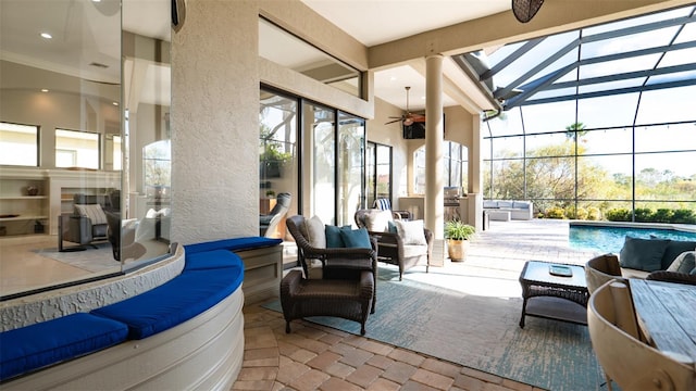 view of patio with an outdoor hangout area, ceiling fan, a lanai, and an indoor pool