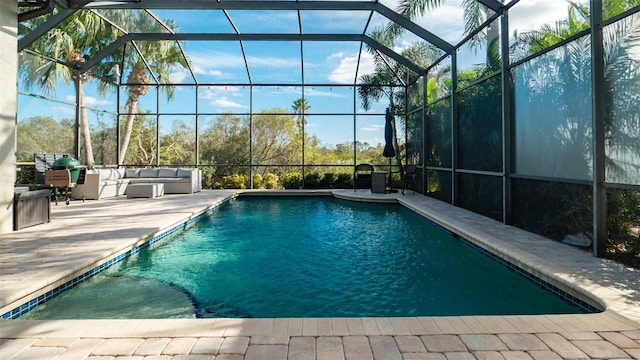 view of swimming pool featuring glass enclosure and a patio area