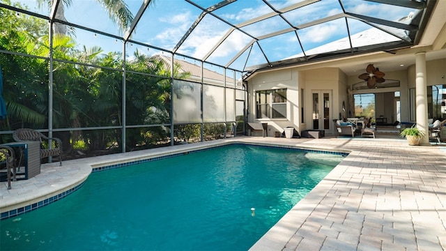 view of pool featuring a lanai, ceiling fan, and a patio area