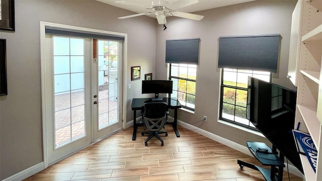 home office with ceiling fan, light wood-type flooring, a wealth of natural light, and french doors