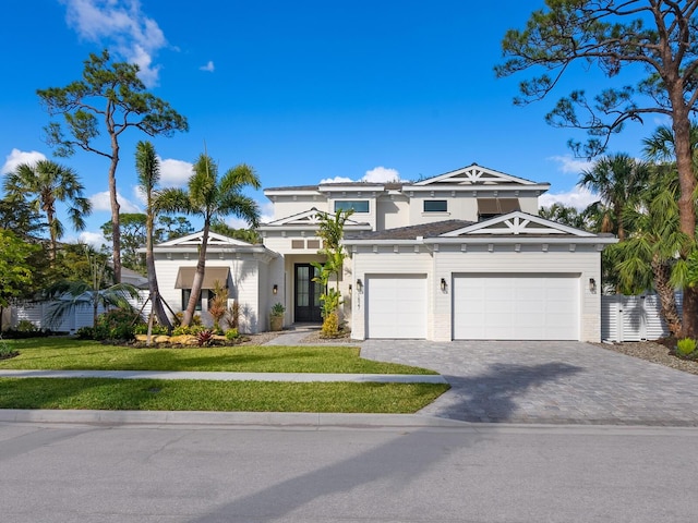 view of front of home with a garage and a front yard